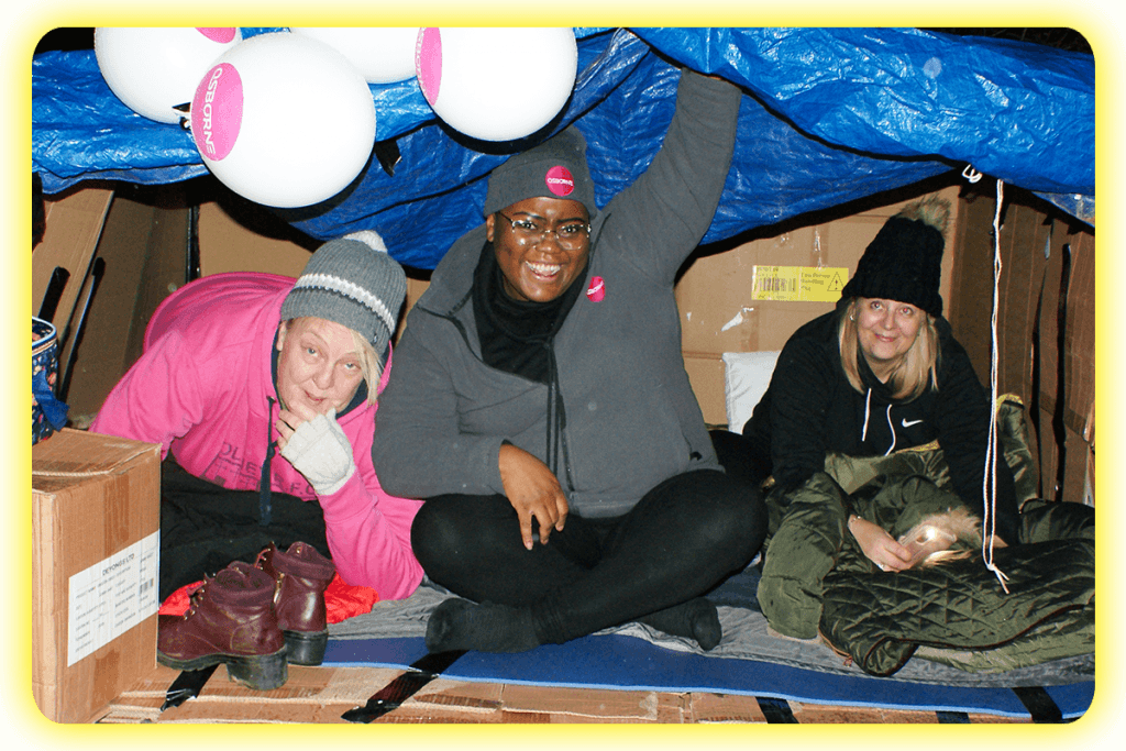 Three woman from a business taking part in the DENS Sleepout