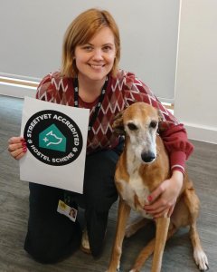 A female DENS staff member with a dog