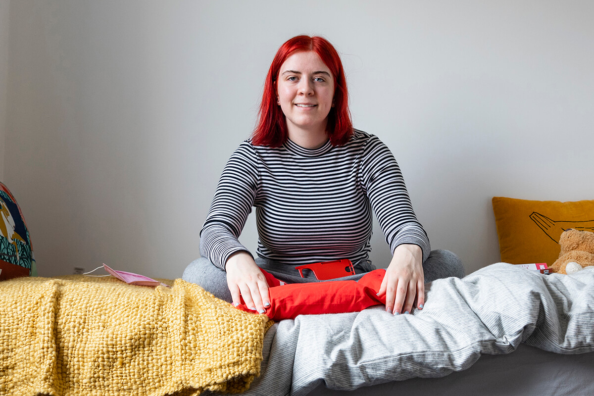 A woman sitting on a bed