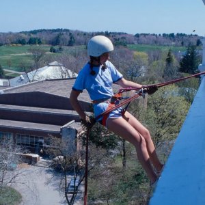 a woman abseiling down a building