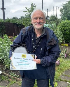 Stephen Hubbard holding his award certificate