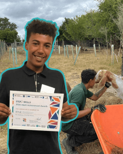 a young man holding up a certificate